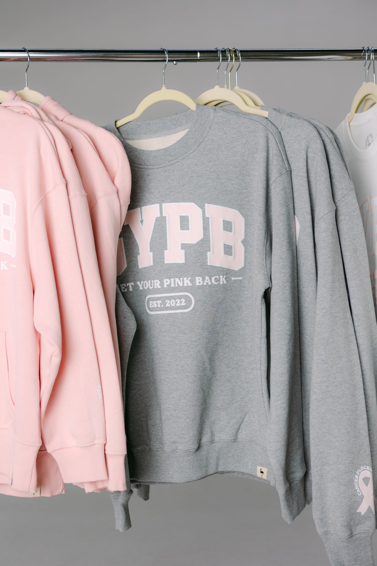 GYPB hoodies and crewnecks on a clothing rack